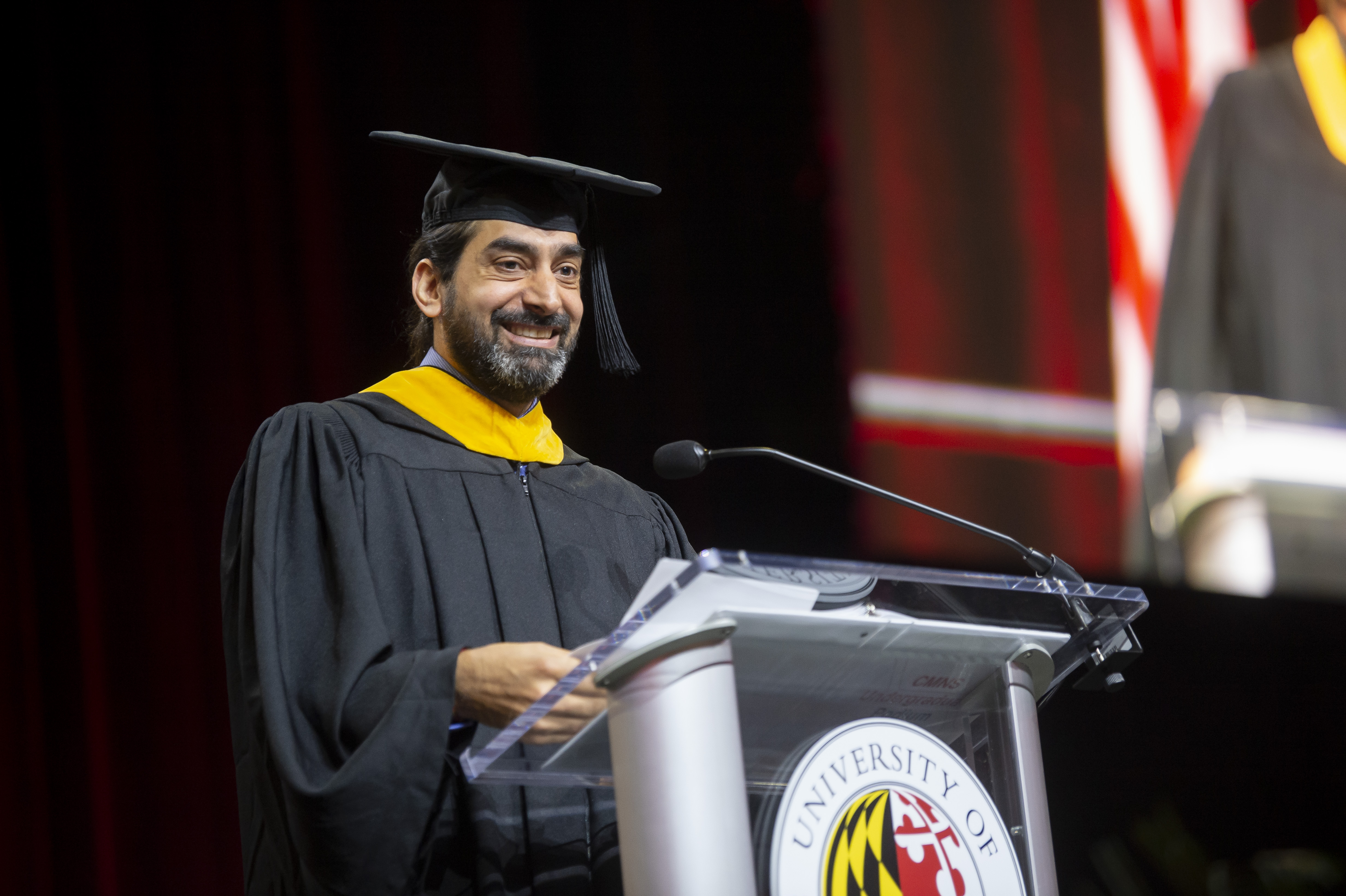 Alum Zeki Mokhtarzada speaking at commencement podium