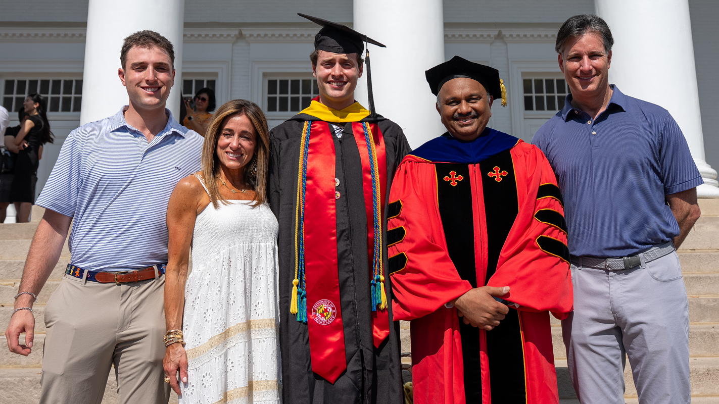 Dean Amitabh Varshney with a Master's graduate and his family/