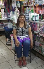 Claudia's mother in their El Salvador market.