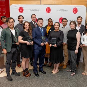 Group photo of awardees in front of a CMNS step-and-repeat banner