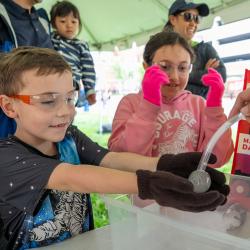 Kids participating in an experiment at Maryland Day 2025