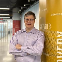 Mihai Pop leaning against a column